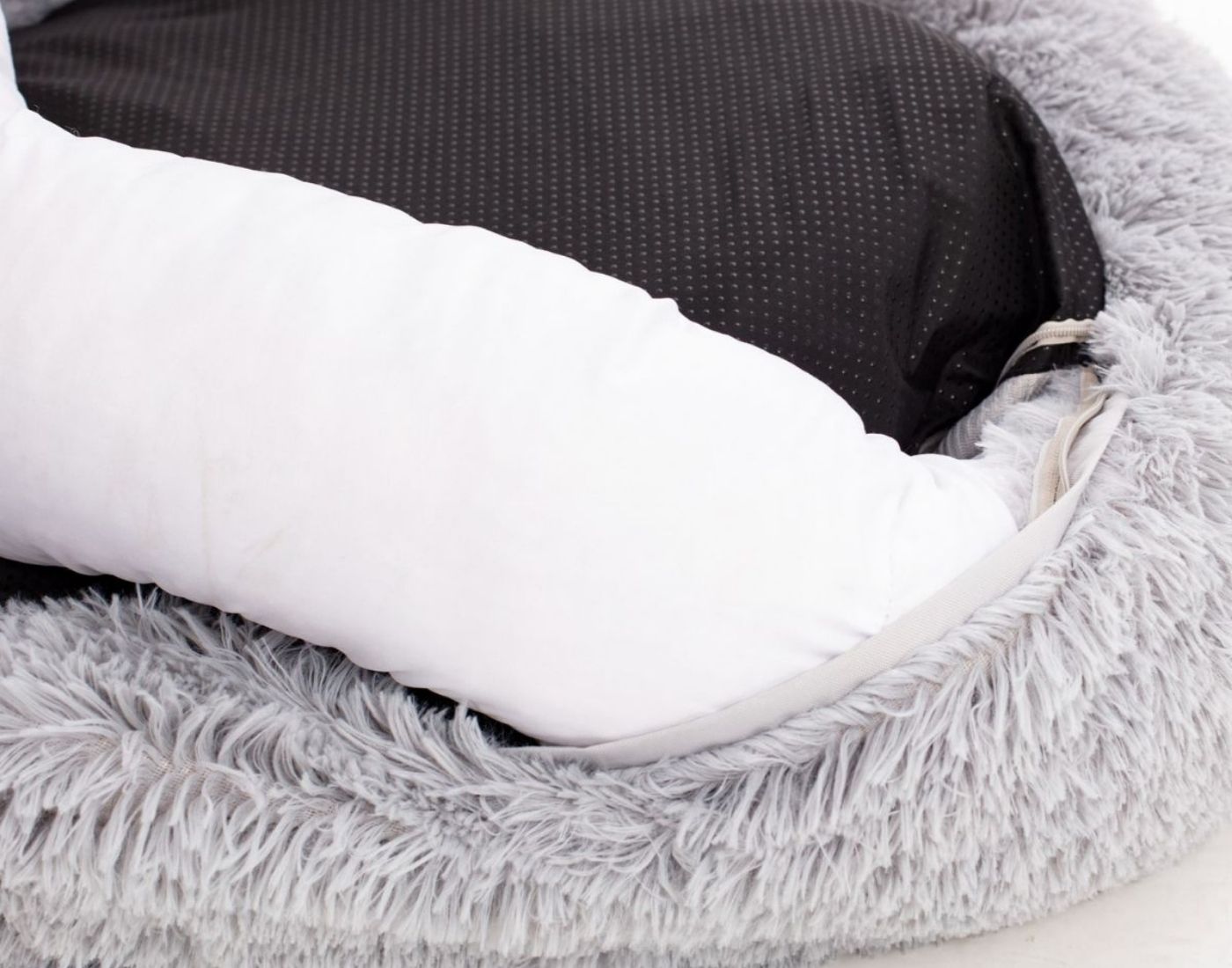 Detail eines flauschigen grauen Hundebetts mit Reißverschluss und abnehmbarem Bezug